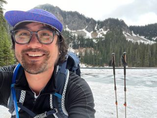 Matt pausing at an alpine lake in the Mount Baker Snoqualmie National Forest.
